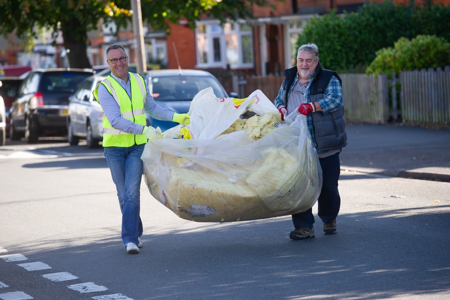 Two men carrying litter