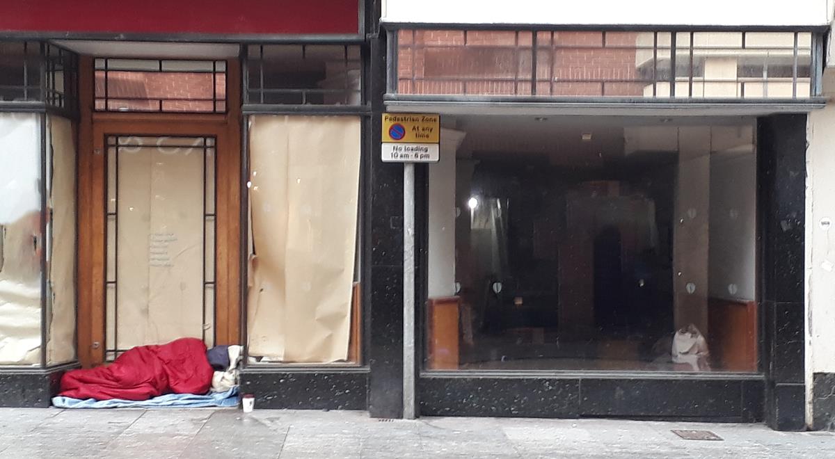 Homeless man in shop doorway