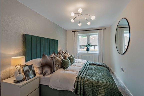 A double bedroom at The Spires in Great Gonerby, Grantham. With large green headboard available as Shared Ownership.