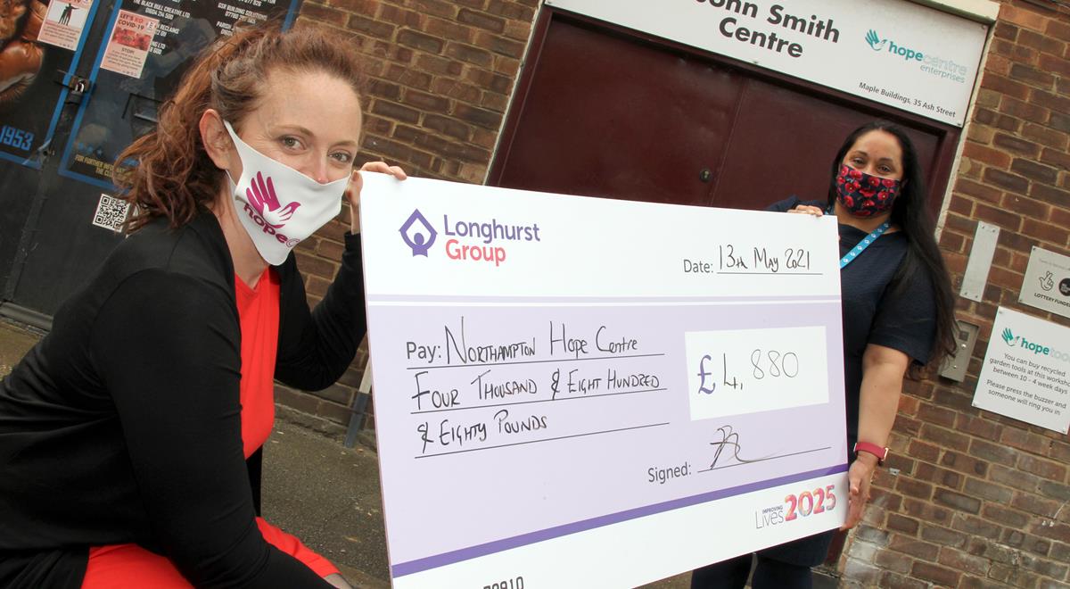 Two women holding a cheque for Northampton Hope