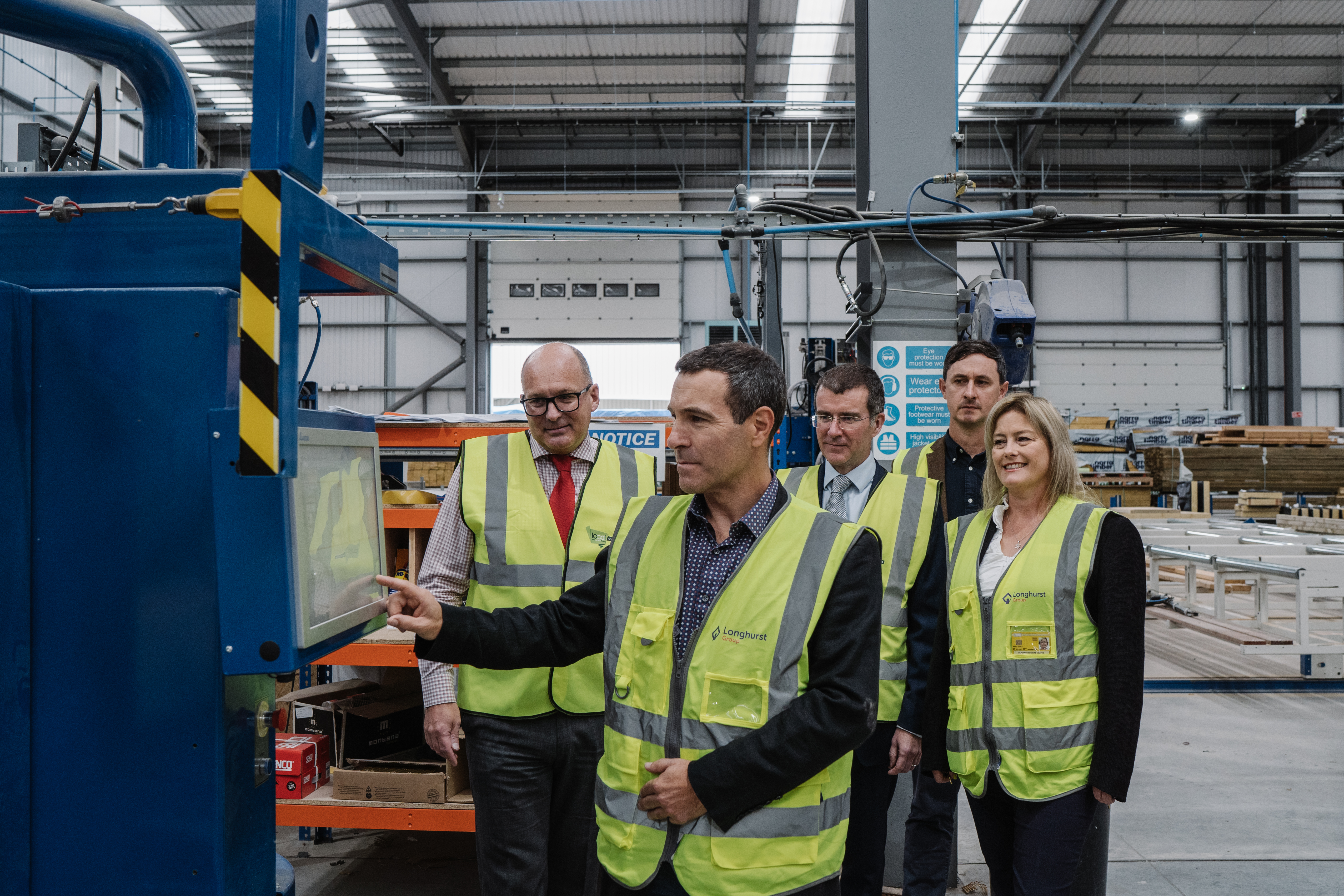 Marcus Keys pressing a button at the LoCal homes factory