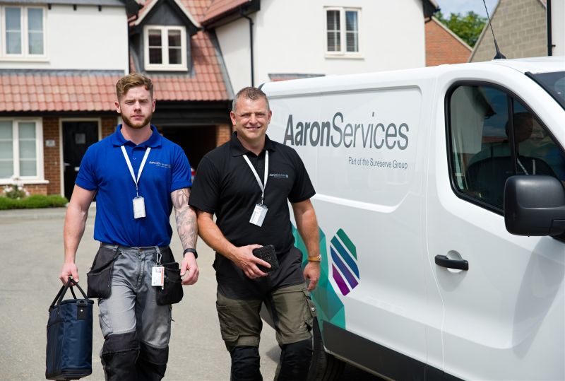 Two men outside a work van