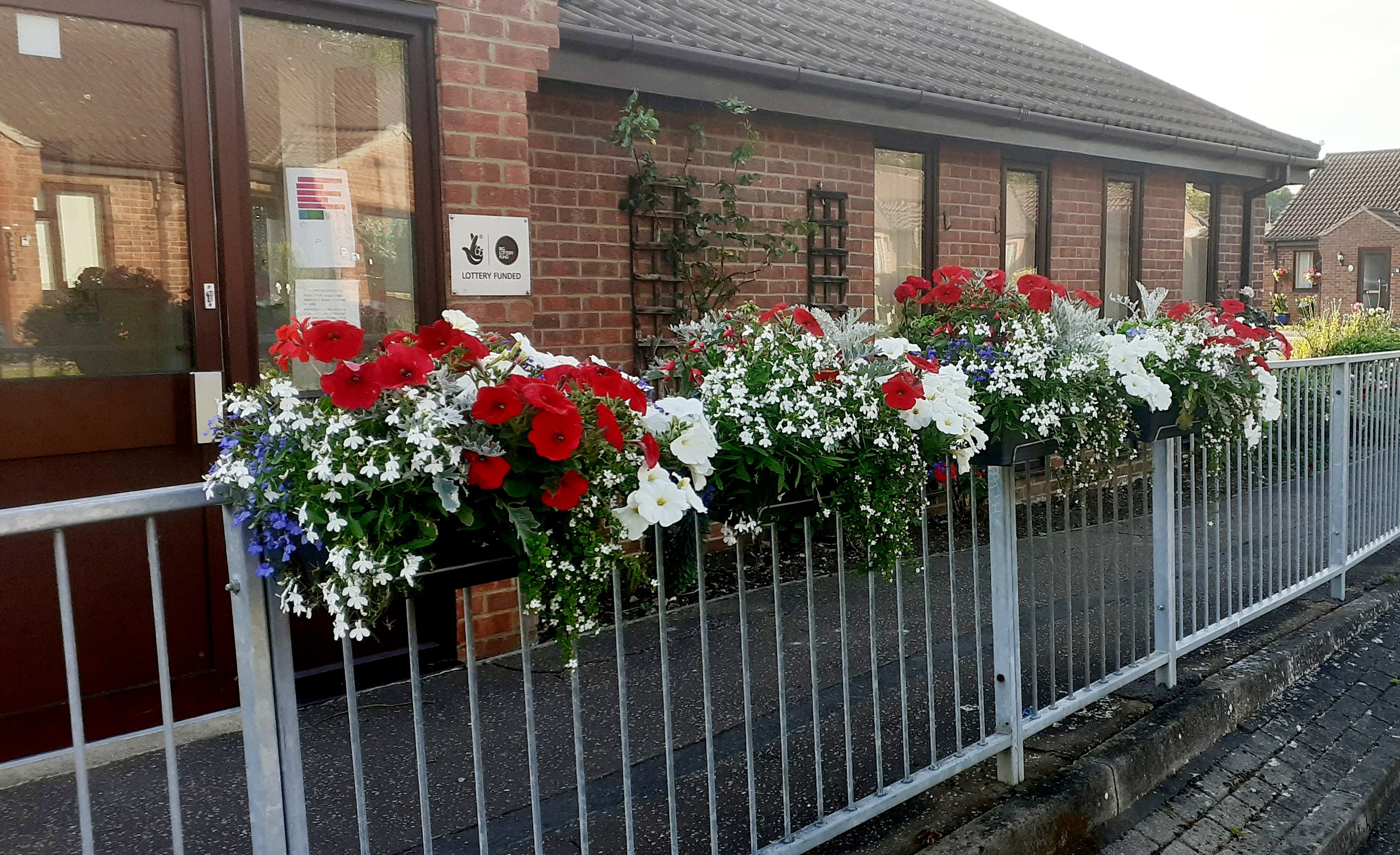 Red and white flowers on railings
