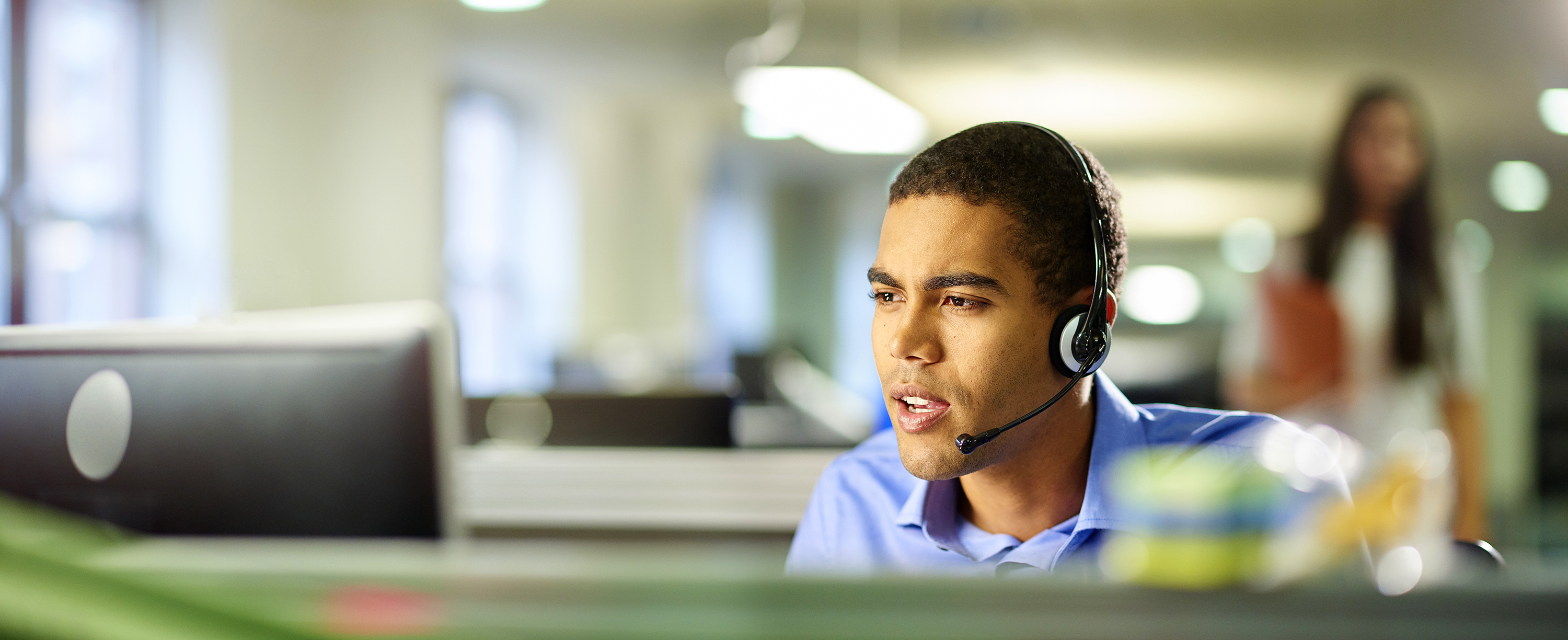 Man with headset on, talking on the phone