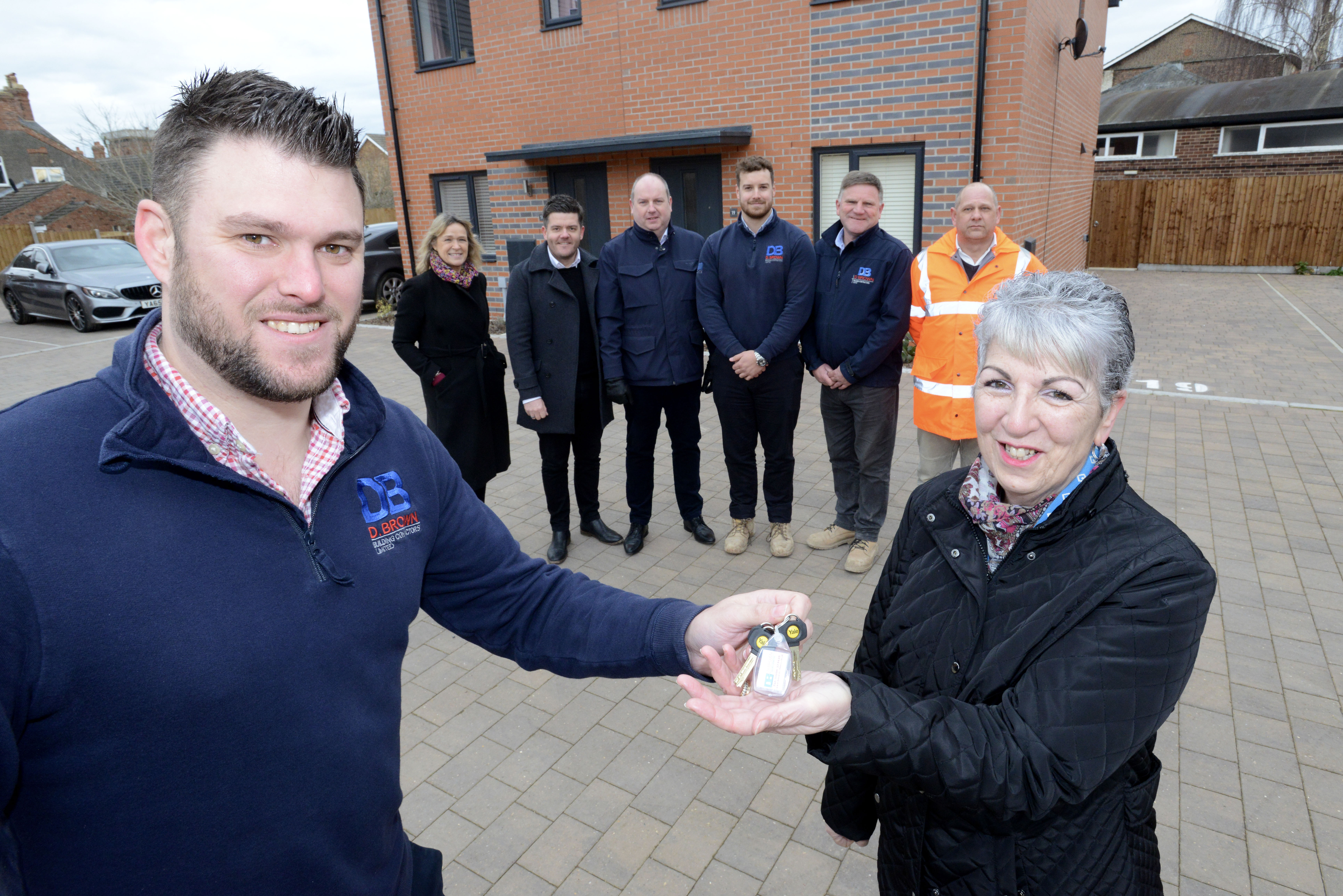 Men and women taking handover of properties