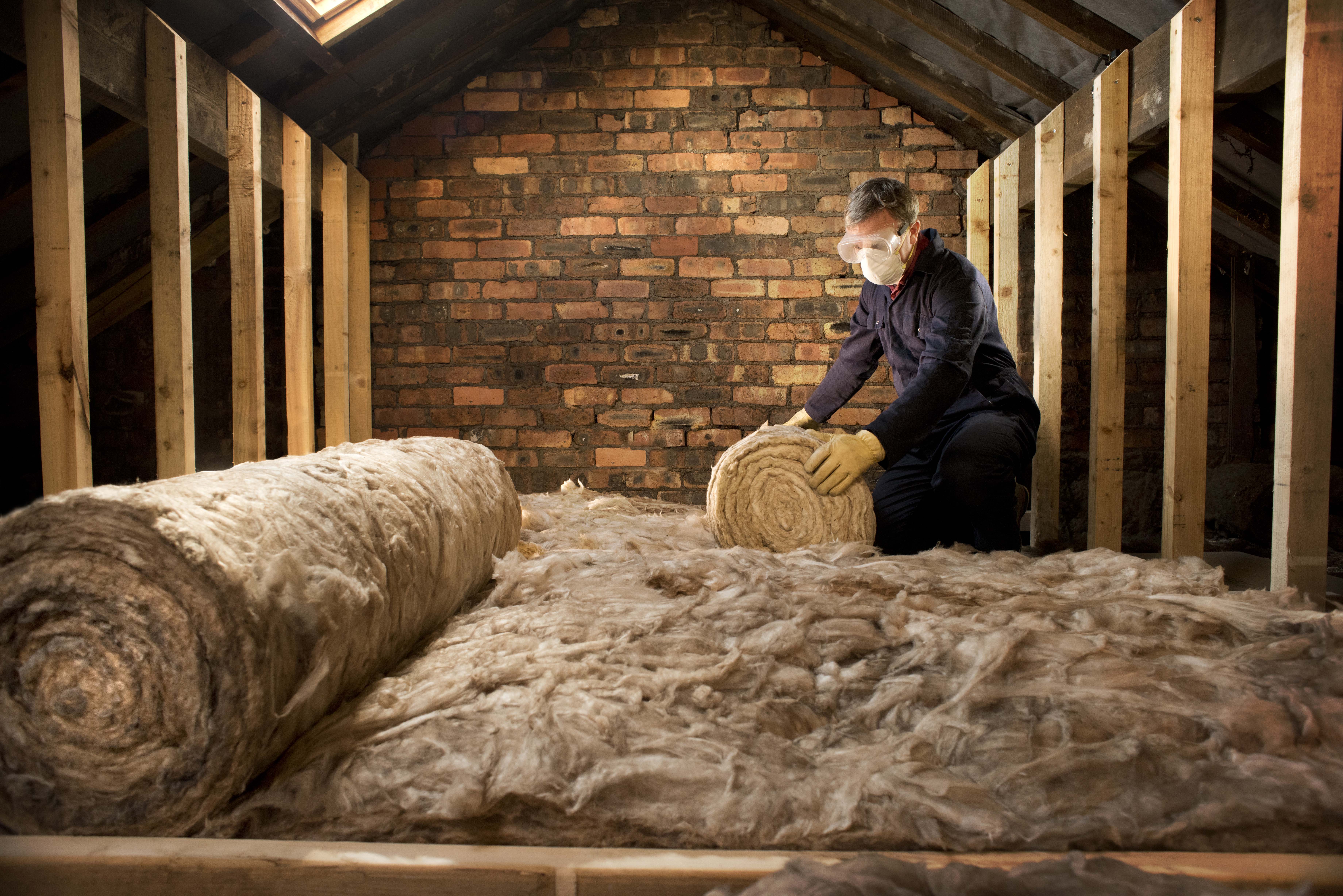 Man in a loft with goggles and a mask on