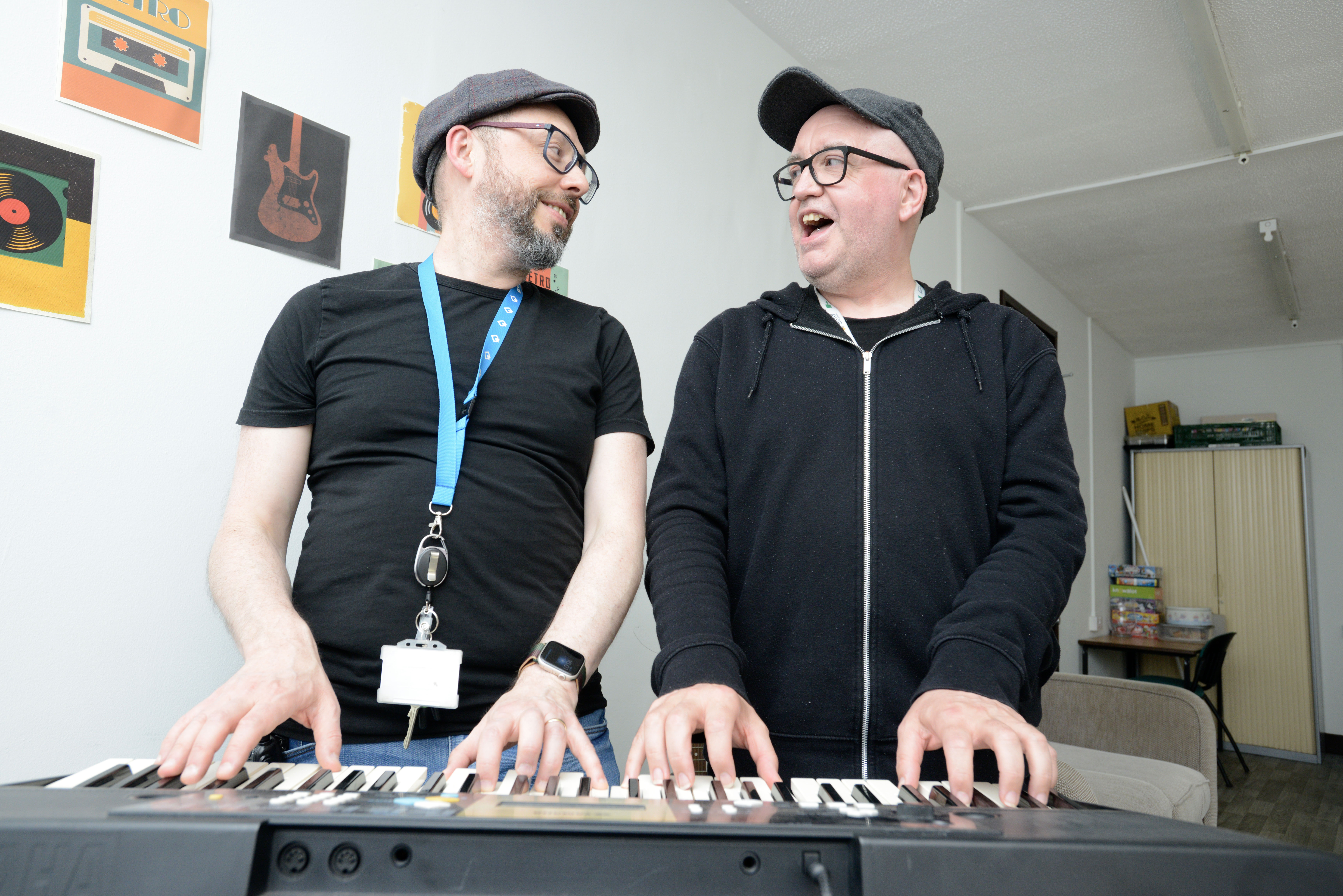 Two men playing the keyboard