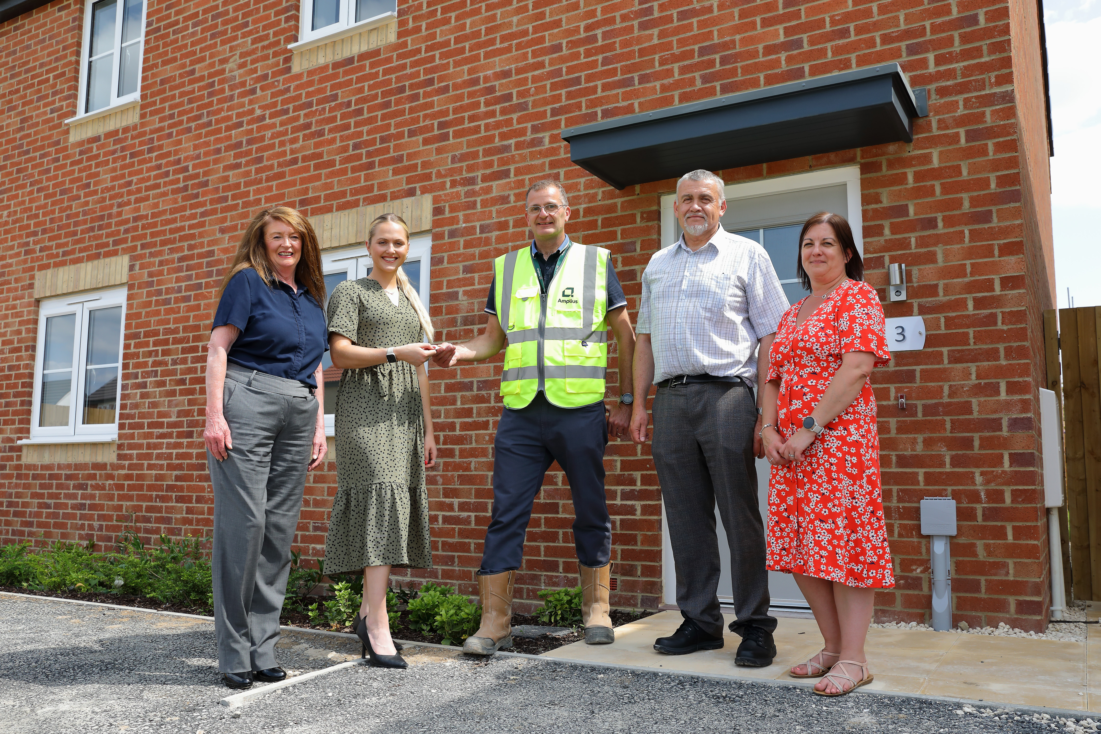 Five people standing in front of new build home