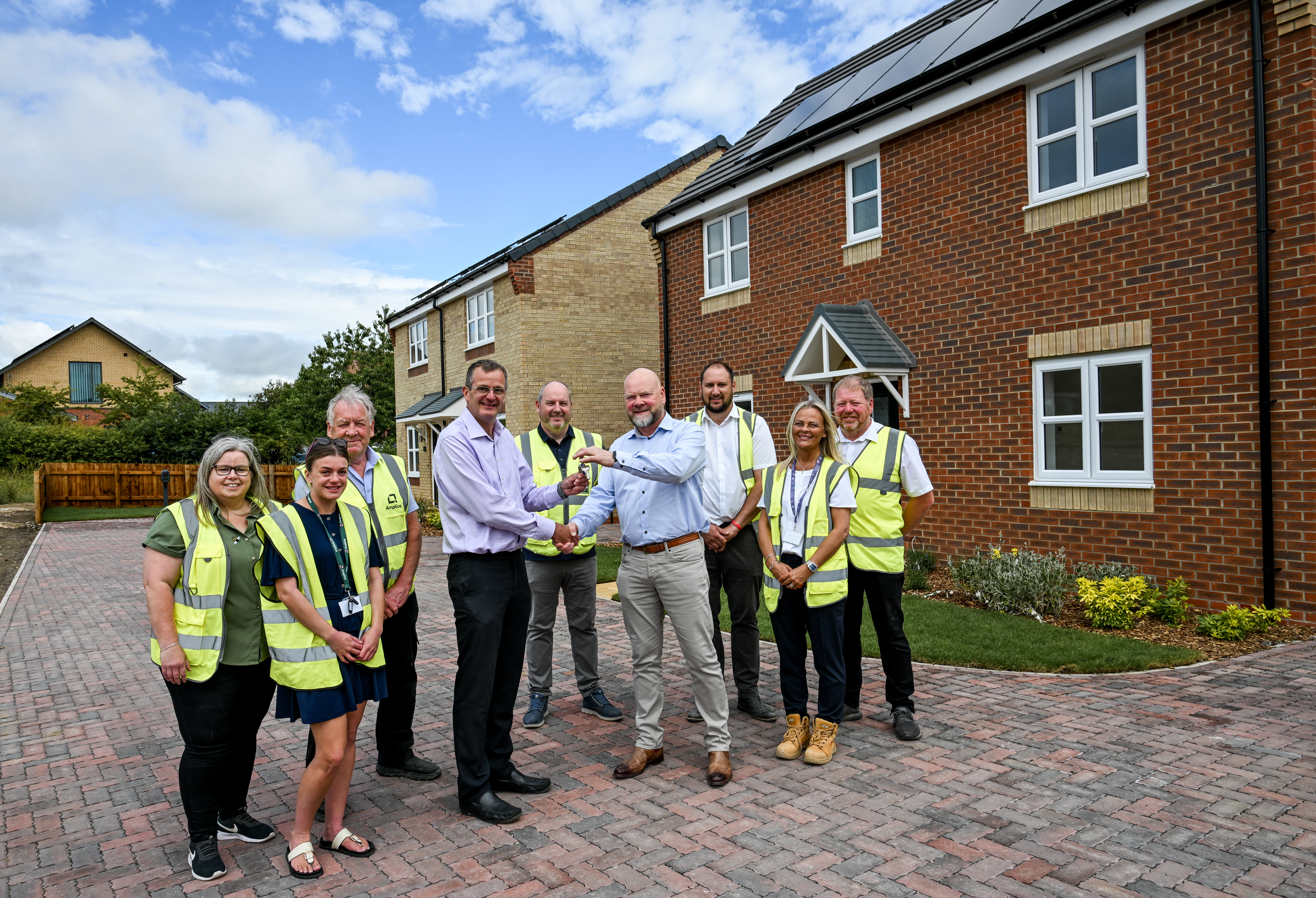 Group of people outside new build
